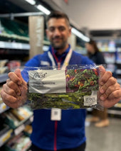 Tesco staff showcasing Purple Sprouting Broccoli at a Tesco Low Carbon Concept Farm store