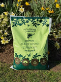 Wildmore Compost 40L Premium All Purpose Peat Free Compost Pallet for gardening and planting needs in Garden in Front of Daffodils